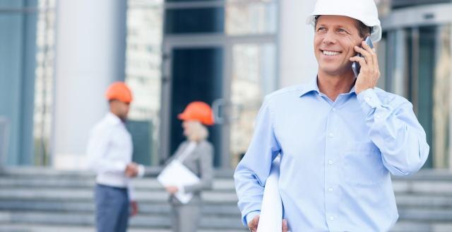 Professional engineer is discussing project on telephone